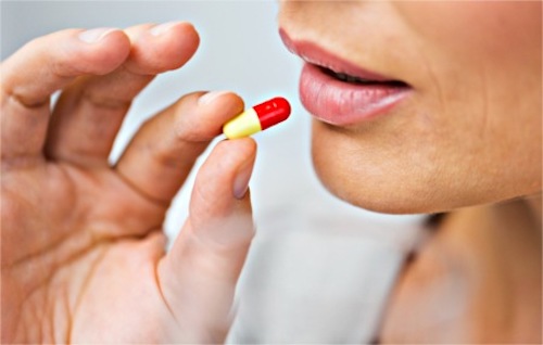 A woman taking an antibiotic 
