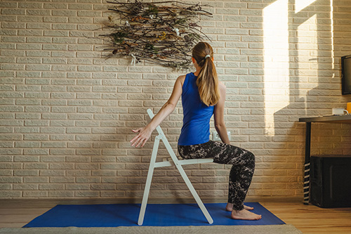 Woman in a chair practicing yoga