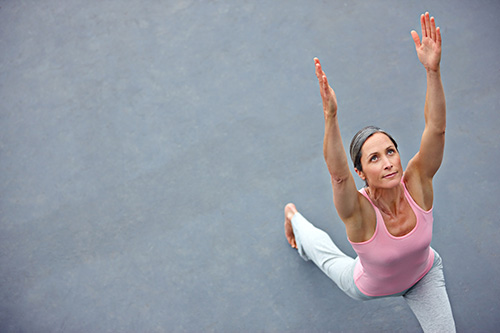 A woman concerned about hormonal bone loss doing yoga