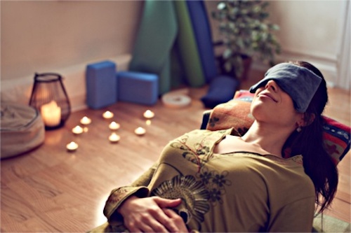 A woman practicing restorative yoga