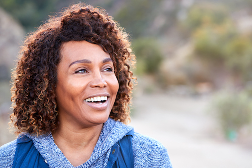 Woman happy to be knowledgeable about low bone density. 
