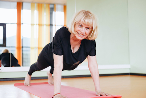Woman in menopause exercising to improve bone and muscle mass. 